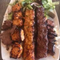 32. Mix Grill · A combination of doner kebab, chicken shish, lamb Adana and beef shish kebab; served with tr...