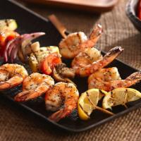 38. Shrimp Shish · Grilled shrimp served with rice and salad.