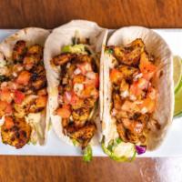Shrimp Tacos · Blackening spice, avocado crema, citrus veggie slaw, pico, pickled jalapeno, and soft flour ...
