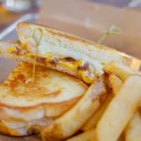 Short Rib Grilled Cheese Sandwich · Italian panini bread, American, brie and Swiss cheese, pulled short rib, and Aioli.
