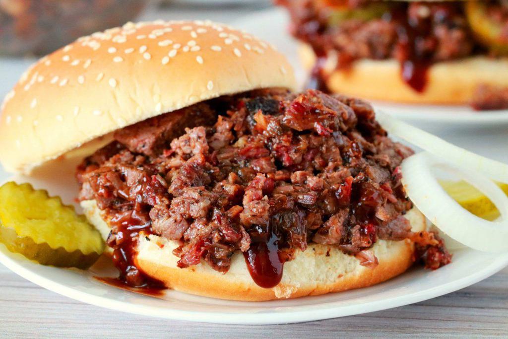 Chopped Beef Brisket Sandwich · Simple 12 hours smoked brisket to perfection and served with onions and pickles