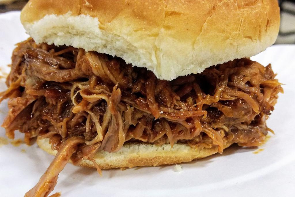 Pulled Pork Sandwich · Simple 12 hours smoked to perfection and served with onions and pickles