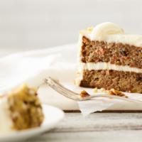 Carrot Cake Slice · Two-layer cake with shredded carrots, pineapple, sweetened coconut and pecan pieces, covered...