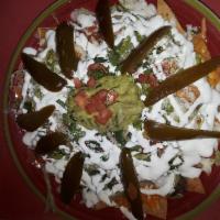 Chicken Nachos · Served with beans, melted cheese, lettuce, sour cream, tomatoes, jalapeno and cilantro and g...