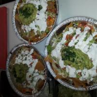 Carnitas Nachos · Served with beans, melted cheese, lettuce, sour cream, tomatoes, jalapeno and cilantro and g...