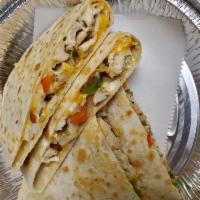 CRISPY Chicken Quesadilla · Grilled chicken, peppers, onions, mozzarella cheese and cheddar cheese. Served with guacamol...