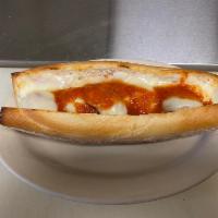 Baked Meatball Parm Sandwich · Sandwich with seasoned meat that has been rolled into a ball topped with tomato sauce and ch...