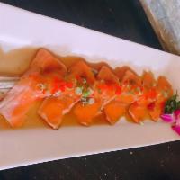 Salmon Tartarki · Seared salmon with yuzu sauce . garnish with red tobiko and  scallion