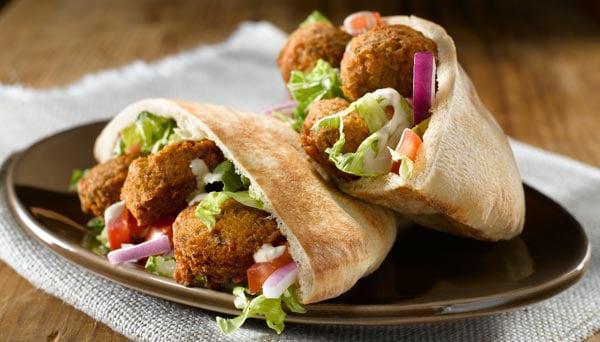 Falafel Sandwich · Falafel, Lettuce, tomatoes, onions, and pickles. Served with tahini and hot sauce.