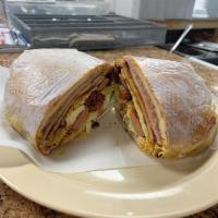 Cuban Torta · Breaded chicken and beef, chorizo, sausage, ham and cheese.