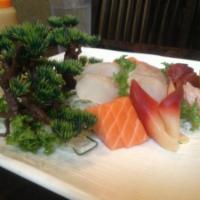 S5. Sashimi Deluxe · 30 pieces assorted slices of raw fish. Served with miso soup and salad.