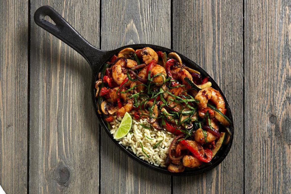 Thai Shrimp · Sautéed shrimp, fresh vegetables, oven-roasted tomatoes and mushrooms in a spicy Thai shrimp sauce. Served with herb rice and topped with basil.