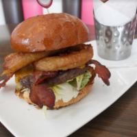 BBQ Smokehouse Burger · Angus beef, bacon, cheddar, BBQ sauce, beer battered rings and romaine. Served with French f...