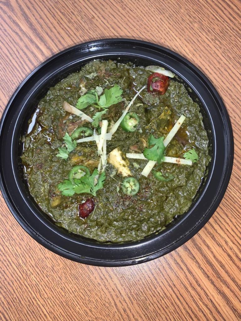 Bone-In Goat and Spinach Curry · Made Using Bone-In Goat Meat, Spinach, Onions, Yogurt, Tomatoes, Ginger- Garlic Paste, Cilantro, Green Chilli, Ginger Slices, Milk, Cumin, black pepper, Turmeric powder and In House Special mix spices.