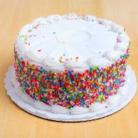 White Cake · Cake with white buttercream icing with confetti sprinkles on the side.