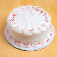 Red Velvet Cake · Red velvet cake with cream cheese icing and red sprinkles garnishing the top.
