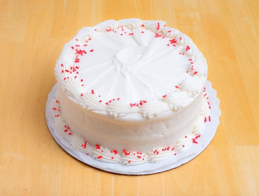 Red Velvet Cake · Red velvet cake with cream cheese icing and red sprinkles garnishing the top.