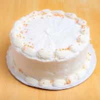 Carrot Cake · Carrot cake with cream cheese icing and orange sprinkles garnishing the top.