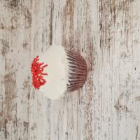 Red Velvet Cupcake · Red velvet cake with cream cheese icing and topped with sprinkles.
