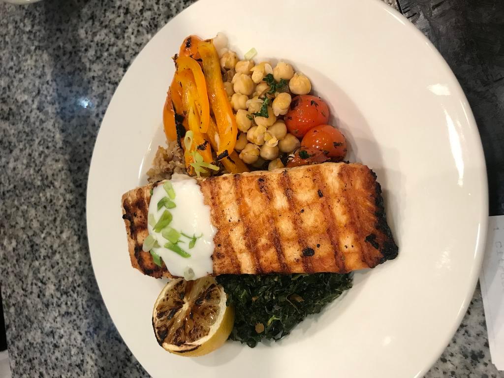 Citrus Salmon Bowl · Cumin-scented Greek yogurt-topped grilled salmon over sautéed Tuscan kale, a hearty blend of quinoa, grains and exotic rice, fire-roasted peppers and grilled lemon.