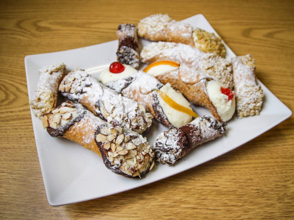 Mini Cream Cannoli w/ Walnuts · A mini version of our authentic, house-made, cannoli-cream filled shell finished with ground walnuts on each end and topped with powdered sugar