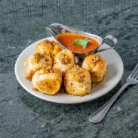 Garlic Knots · 6 pieces. Rolled baked garlic bread. Add mozzarella for an additional charge.