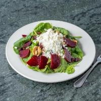 Beet Salad · Beets over baby spinach with cranberries, roasted walnuts and goat cheese.