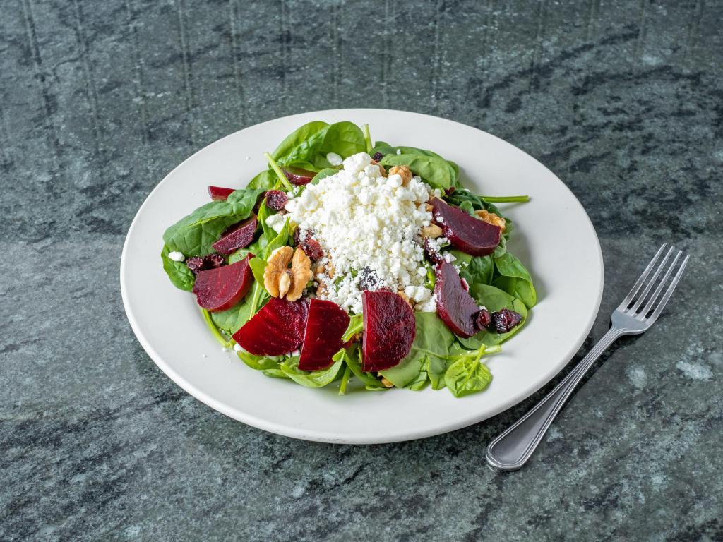 Beet Salad · Beets over baby spinach with cranberries, roasted walnuts and goat cheese.
