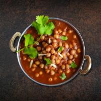 Chickpea N Curry · Chickpeas cooked with juicy onions, tomatoes, and perfectly grounded spices served along wit...