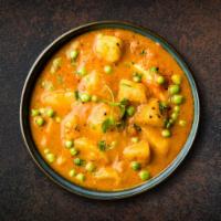 Classic Potato and Peas · Peas and potato cooked with vibrant flavors of fresh tomatoes, onions, ginger, garlic, and c...