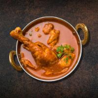 Parliamentary Chicken Curry  · Chicken pieces simmered with jeera, turmeric, and red chili powder cooked with tomatoes with...