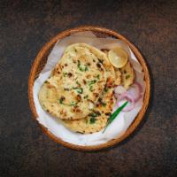 Garlic Naan Fiesta · Fresh made leavened dough infused with garlic and baked in a traditional coal oven.
