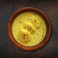 Divine Rasmalai · Cottage cheese patties flattened and soaked in milk with whole spices.
