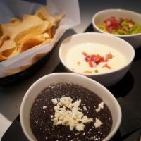 Dip Trio · Chips, house made queso, black bean dip & guacamole