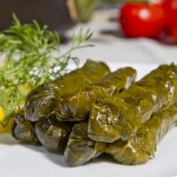Grape Leaves · Hand rolled grape leaves stuffed with tomatoes, onions, lemon juice and rice.
