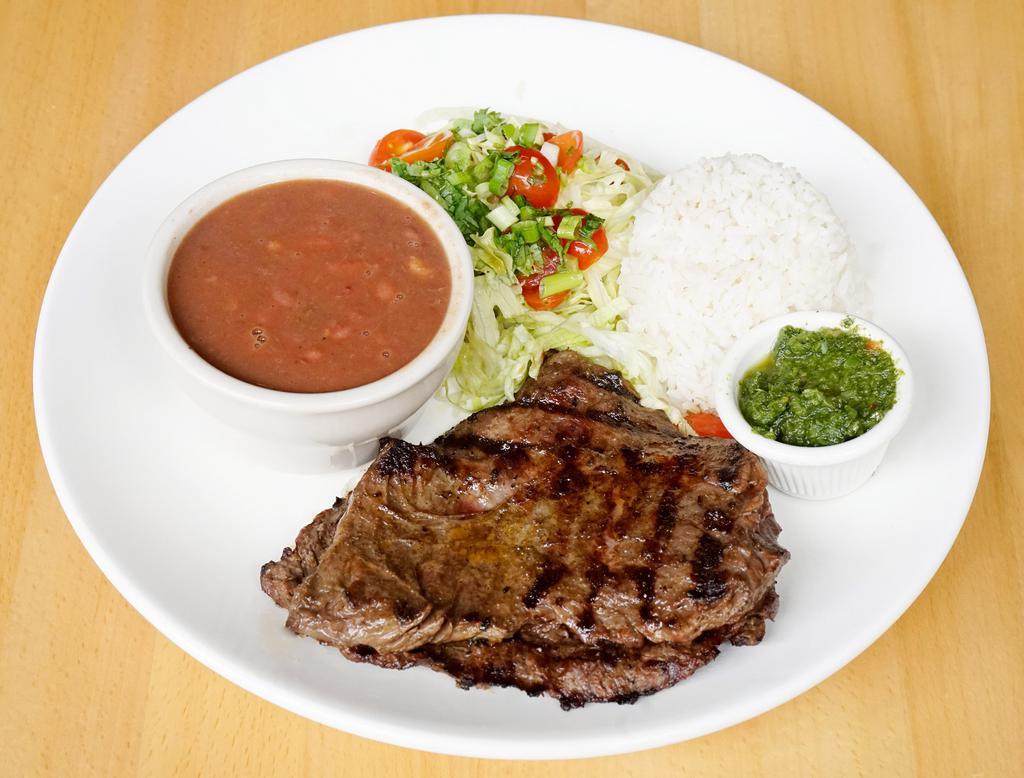 Entrana a la Plancha · 8 oz. grilled skirt steak marinated with traditional Latin herbs and spices, served with white or yellow rice, black or red beans, salad and chimichurri sauce.