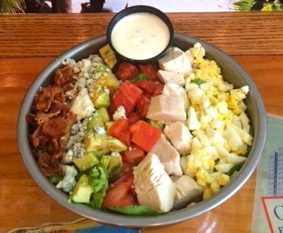 Cobb Salad · Fresh greens with grilled chicken, tomatoes, egg, bacon, avocado and bleu cheese crumbles.
