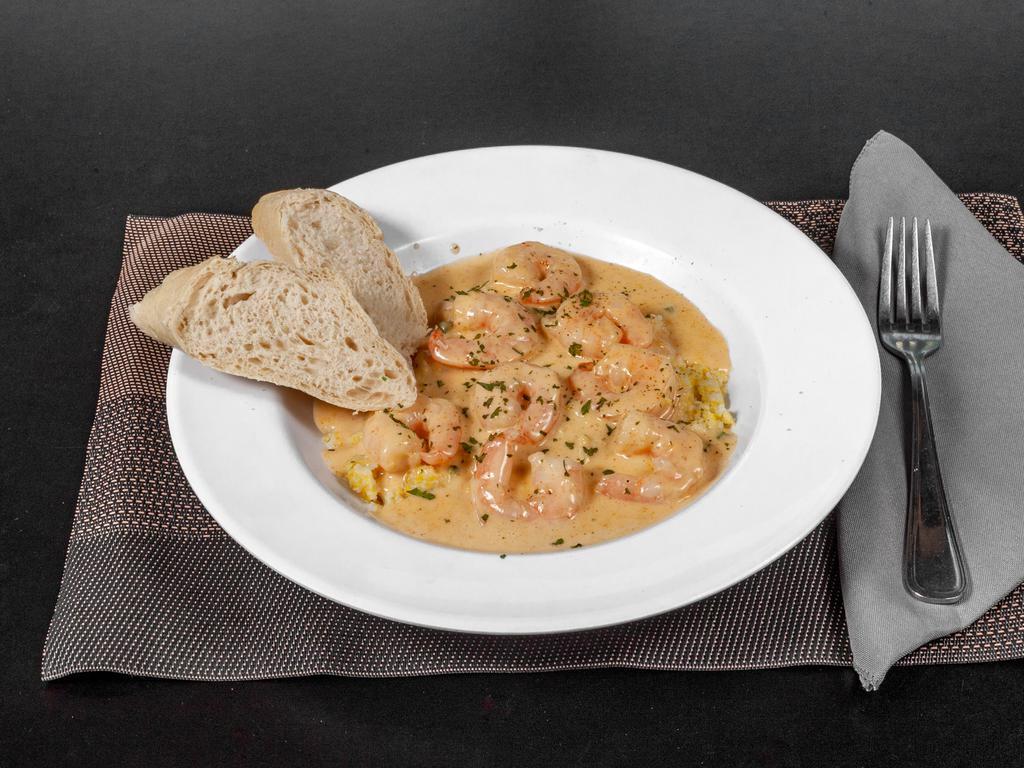 Shrimp & Grits · Sautéed shrimp with stone ground grits in our Cajun cream sauce..
Served with a side salad and fresh bread.