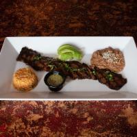 Grilled Skirt Steak · Skirt steak with chimichurri sauce. Served with rice and beans and sliced avocado.