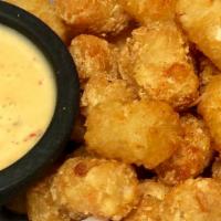 Crispy Queso Tots · Our perfectly crispy tater tots lightly seasoned with a fiesta blend of spices. Comes with a...