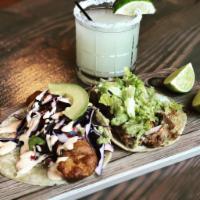 Modelo Battered Fish Tacos (two tacos) · Two Fish tacos, Purple cabbage, chipotle crema and lime. 
