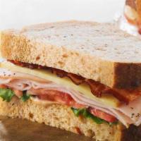 6. Turkey Ranch Sandwich · Turkey, Swiss, bacon, tomatoes, mixed greens and ranch dressing on ciabatta.