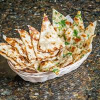 Garlic Naan · Garlic-infused indian flatbread cooked in a clay oven