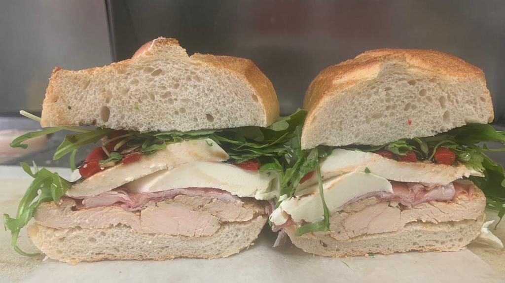 Pauly Walnuts Sandwich  · Grilled chicken, fresh mozzarella, roasted red peppers., prosciutto, mixed greens with balsamic reduction.