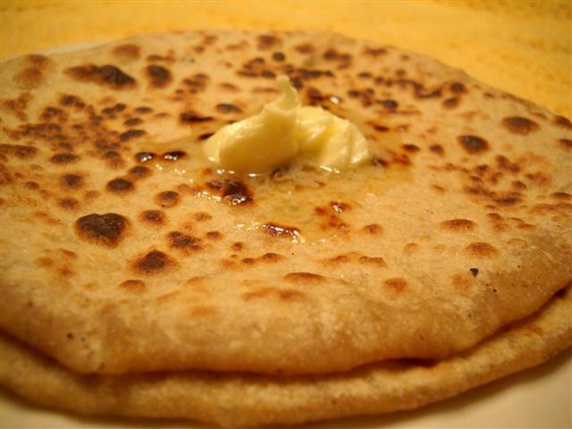 7. Paratha · Whole wheat layered flour buttered soft bread. Freshly baked bread from tandoori clay oven.