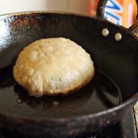8. Poori · Fried fluffy bread. Freshly baked bread from tandoori clay oven.