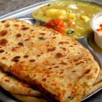 10. Aloo Paratha · Whole wheat bread stuffed with potatoes, peas, pepper and onions cooked in a pan. Freshly ba...