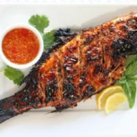 7. Whole Fish Tandoori · Red snapper grilled with onions, peppers served with spinach. Served with basmati rice.