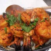 11. Tandoori Shrimp · Big size marinated shrimp cooked in clay oven, served fresh spinach. Served with basmati rice.
