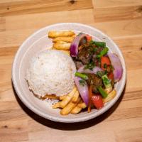 Steak Stir Fry (Lomo Saltado) · Sliced beef chunks sautéed with red onions and tomatoes, served over french fries